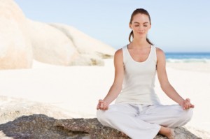 Young woman meditating at beach Young woman meditating at beach